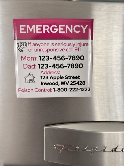 A refrigerator door with a printed emergency contact card attached. The card has a pink header reading 'EMERGENCY' and white background with black and pink text listing Mom's phone, Dad's phone, an address, and Poison Control.